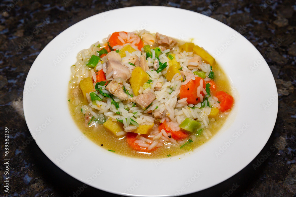 Traditional chicken soup with vegetables typically served in hospitals
