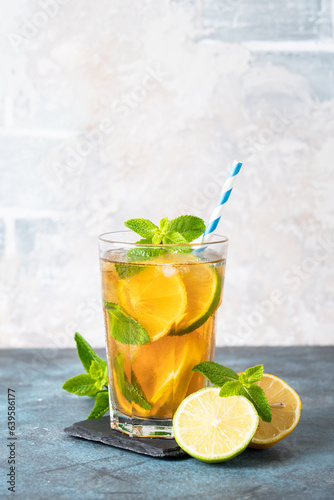 Iced tea, Cold lemonade, summer drink at kitchen table. Vertical image.