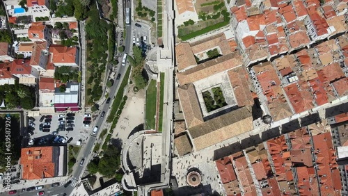 A camera drone flies ahead above west walls of Dubrovnik Old Town, Croatia photo
