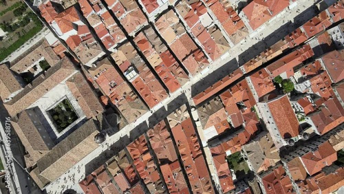 A camera drone flies ahead above roofs of Dubrovnik Old Town, Croatia photo