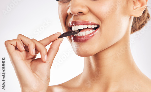 Woman  chocolate and mouth for eating  studio and healthy with nutrition  diet and bite by white background. Girl  model and cacao for wellness  detox or cosmetics with detox  teeth or antioxidants