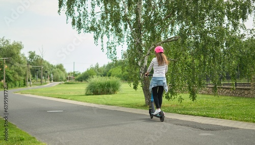 Happy woman using e-scooter, e-roller