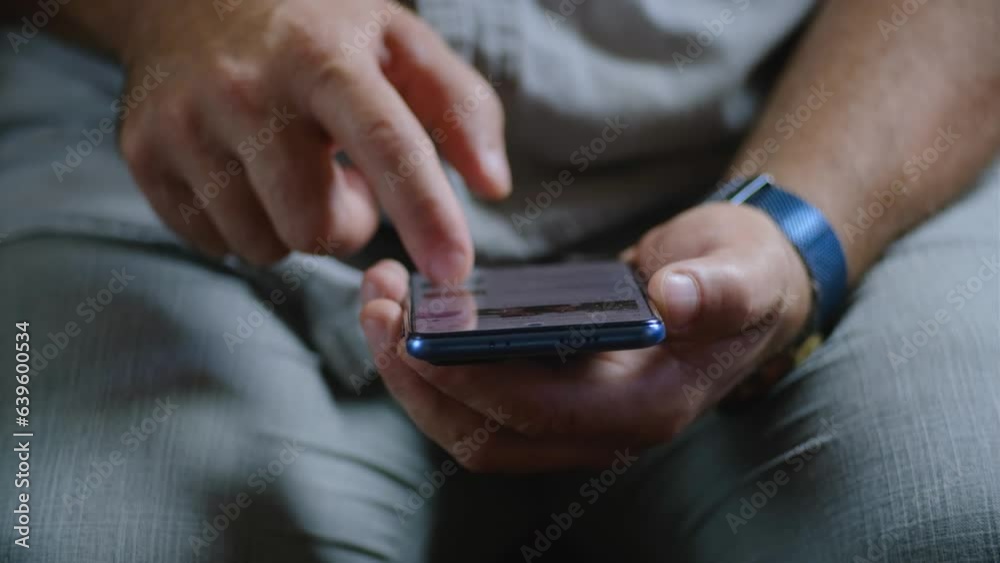 a man flips through a news feed on his phone a man flips through a news feed on his phone