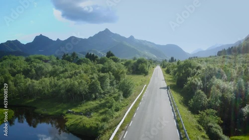 Drone flying over a road with Lofoten mountains in the backround photo
