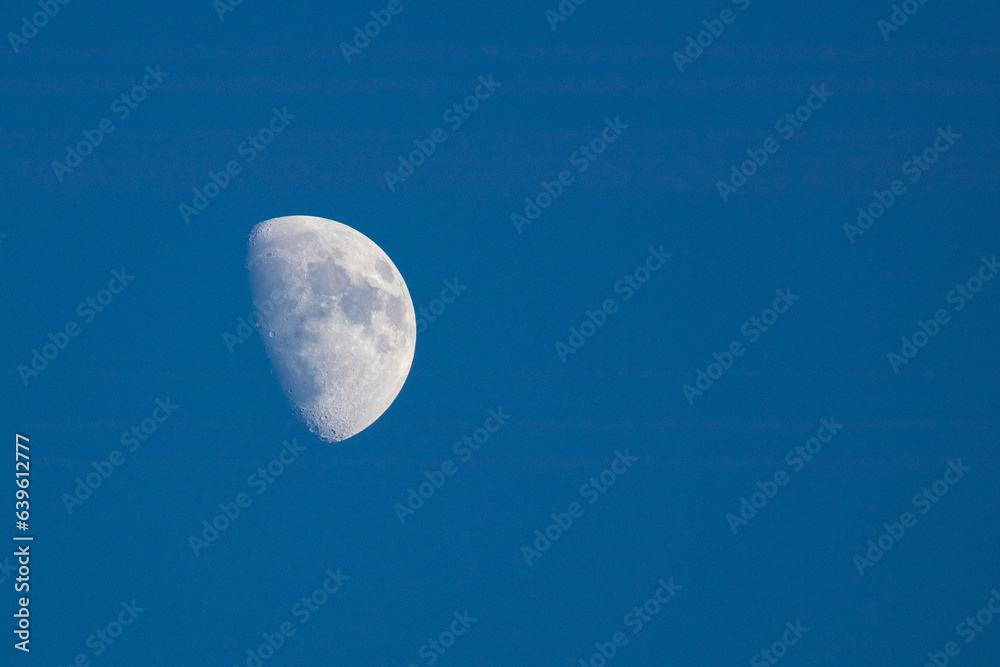 Half moon in the afternoon blue sky Half moon in the afternoon blue sky
