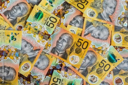 Australian currency - cash of fifty dollar notes scattered and filling frame photo