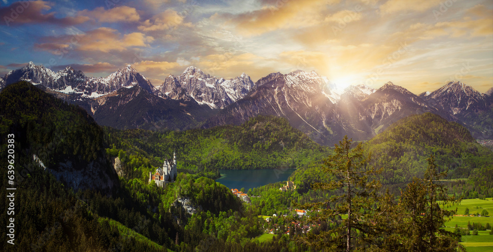 Alpine mountain view in the evening light on a sunny day in summer at Neuschwanstein Castle and the Alpsee lake in Allgau, Germany with a view of the Allgau Alps