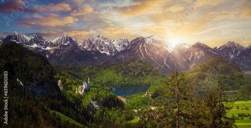 Alpine mountain view in the evening light on a sunny day in summer at Neuschwanstein Castle and the Alpsee lake in Allgau, Germany with a view of the Allgau Alps © HLPhoto