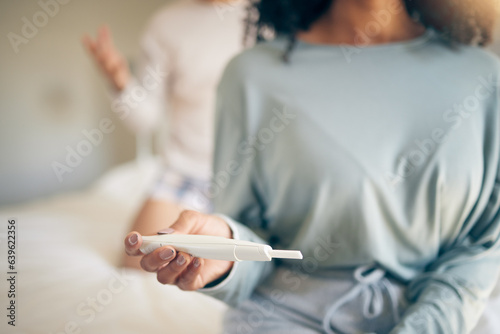 Hands, woman and bed with pregnancy test, closeup and home for results, planning or news to start family. Girl, exam and notification in bedroom, apartment and anxiety for maternity, future or baby