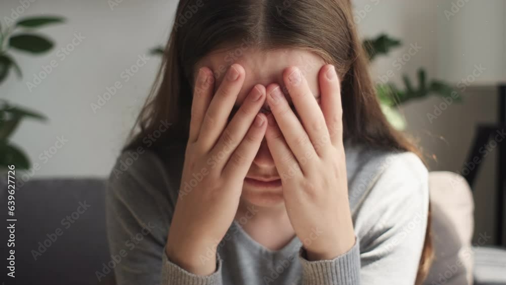 Close up of frustrated sad girl covering face, sit on sofa at home alone, upset young woman suffering from break up with boyfriend or divorce, bad relationship, feeling lonely and depressed concept Close up of frustrated sad girl covering face, sit on sofa at home alone, upset young woman suffering from break up with boyfriend or divorce, bad relationship, feeling lonely and depressed concept