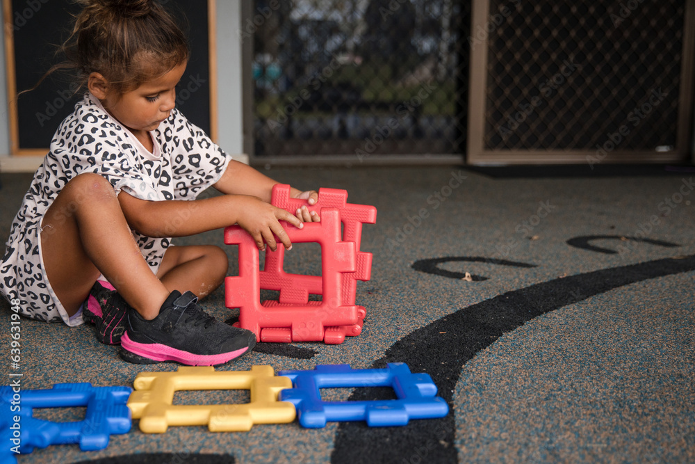 © Austockphoto - Young Aboriginal girl playing at preschool with plastic toy © Austockphoto - Young Aboriginal girl playing at preschool with plastic toy