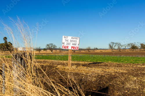 Sign protesting forced land acquisition for Singleton Bypass