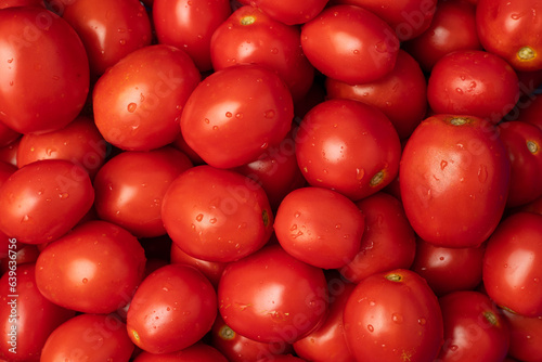 Red tomatoes are laid out on the table © Olena