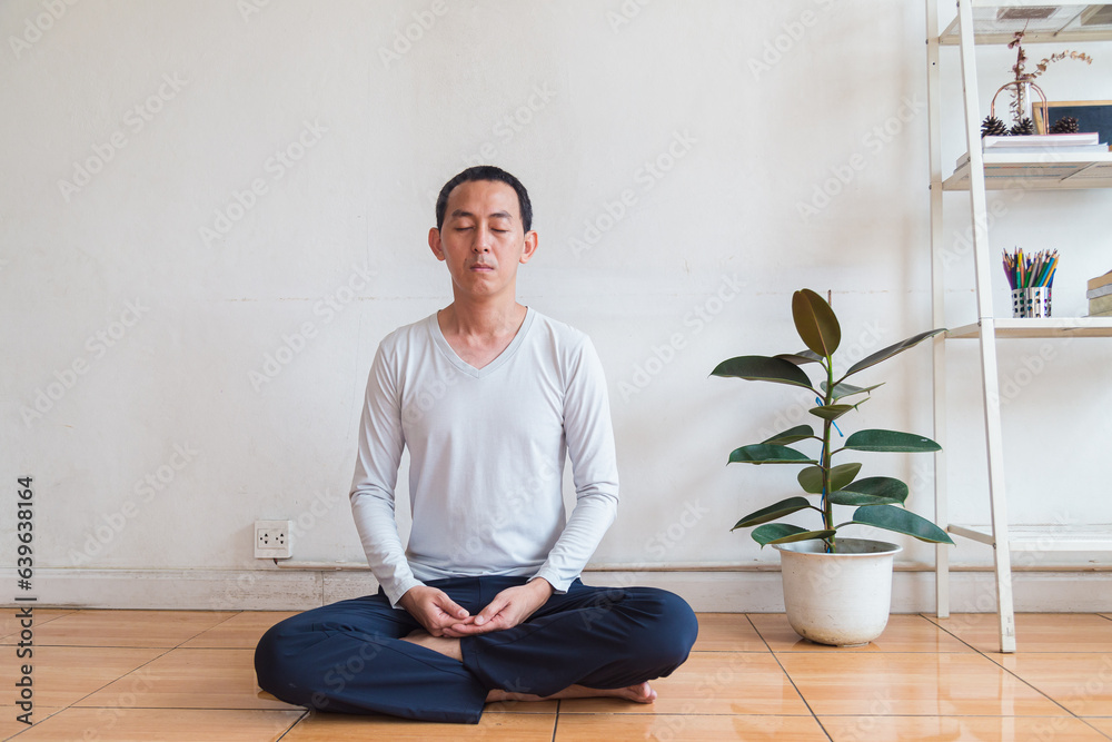 Meditation, zen asian man in relax, peace and mental health in house living room Meditation, zen asian man in relax, peace and mental health in house living room