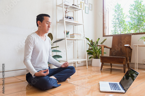 Meditation, zen asian man in relax, peace and mental health in house living room