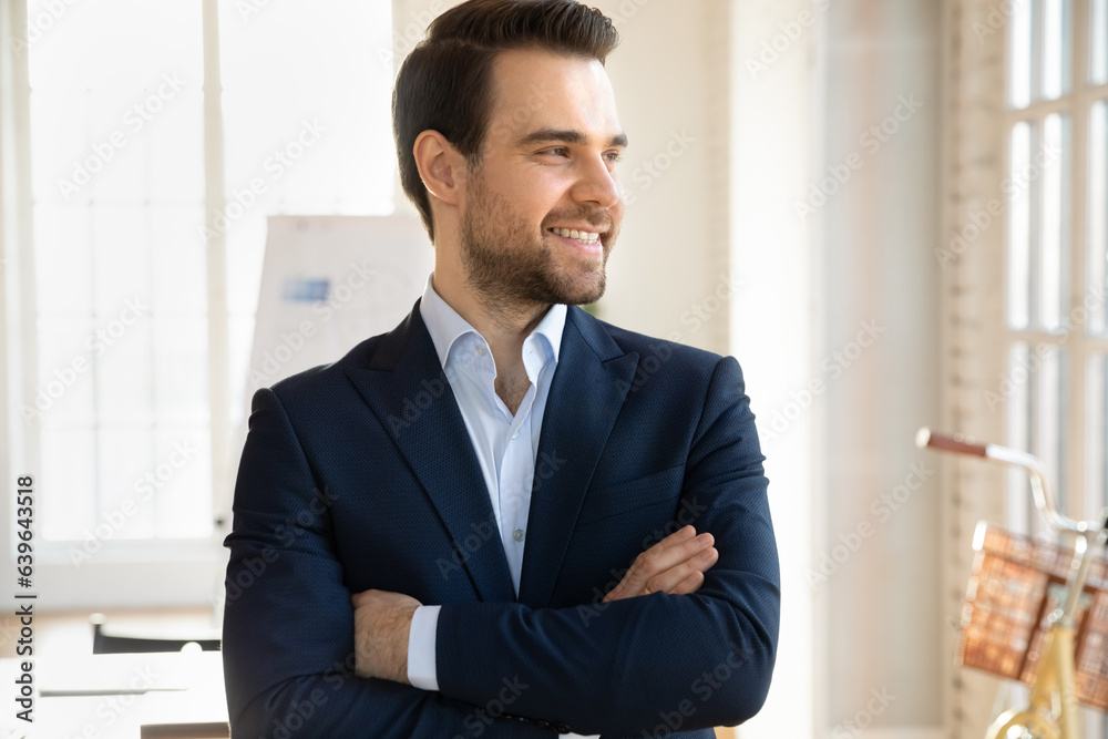 Smiling of young Caucasian male boss or director in formal suit look in distance in office thinking or pondering, happy businessman lost in thoughts consider career success or business opportunity Smiling of young Caucasian male boss or director in formal suit look in distance in office thinking or pondering, happy businessman lost in thoughts consider career success or business opportunity