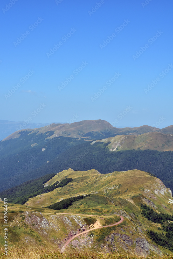 Summer day mountain landscape with blue sky and copy space for travel text.