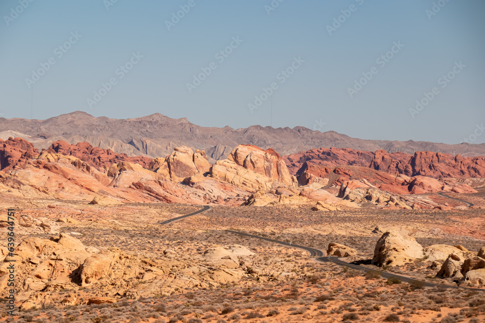 Panoramic view of endless winding empty Mouse tank road in Valley of Fire State Park through canyons of red Aztec Sandstone Rock formations and desert vegetation in Mojave desert, Overton, Nevada, USA Panoramic view of endless winding empty Mouse tank road in Valley of Fire State Park through canyons of red Aztec Sandstone Rock formations and desert vegetation in Mojave desert, Overton, Nevada, USA