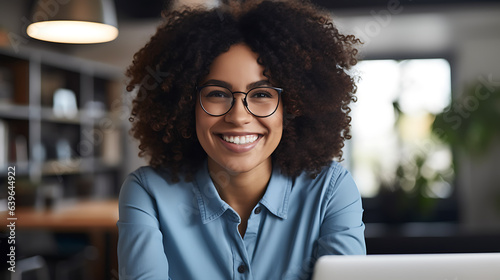 Close up portrait of young beautiful african american woman smiling while working with laptop in office.Created with Generative AI technology.