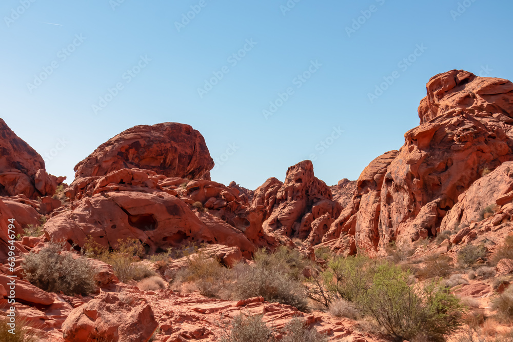 Scenic view of beehives red sandstone rock formations in Petroglyph Canyon on Mouse Tank hiking trail in Valley of Fire State Park, Mojave desert, Nevada, USA. Holes formed by geologic cross bedding