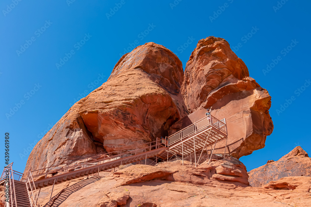 Scenic view of staircase of Atlatl rock showing the ancient Indian petroglyphs carvings of the Anasazi in Valley of Fire State Park in Mojave desert, Nevada, USA. Aztek red sandstone rock formation