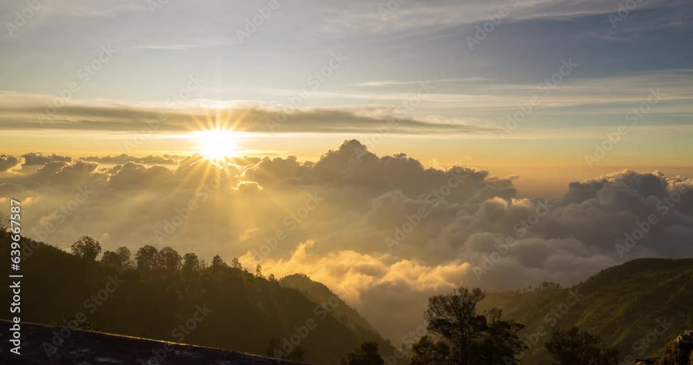 Timelapse of the sun setting over layers of rolling clouds on the mountain, taken in Mount Bromo, Indonesia	