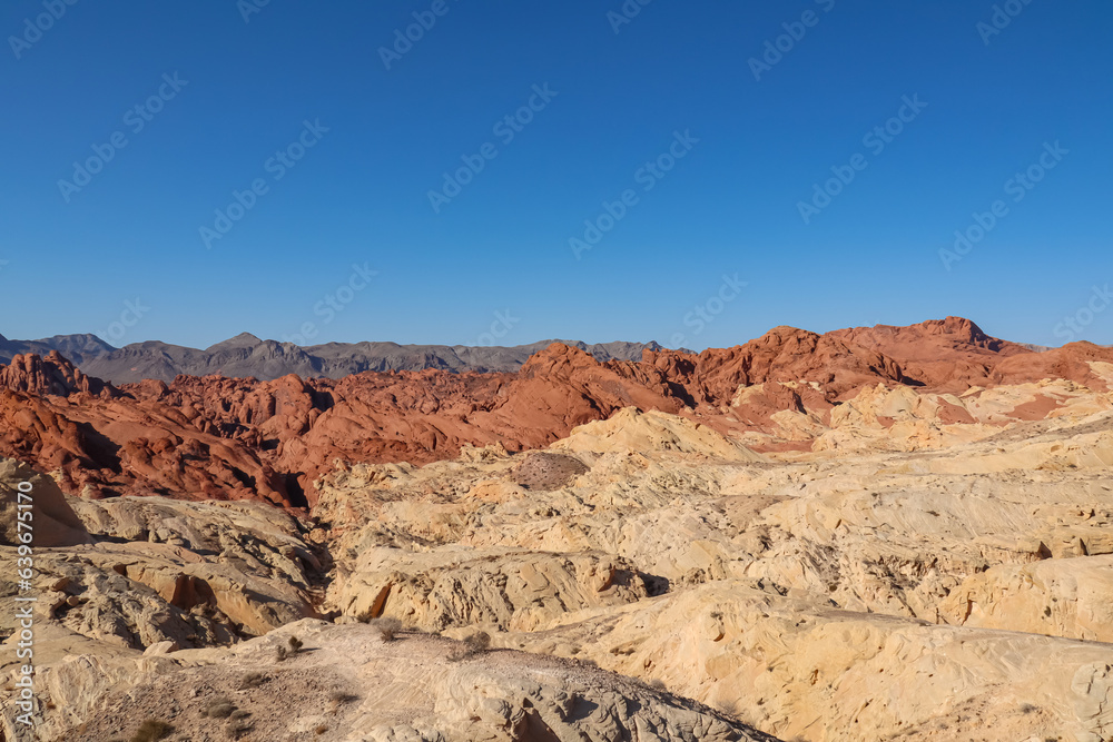 Scenic view of from Silica Dome viewpoint overlooking the Valley of Fire State Park in Mojave desert, Nevada, USA. Landscape of Aztek sandstone rock formations. Hot temperature in arid vegetation Scenic view of from Silica Dome viewpoint overlooking the Valley of Fire State Park in Mojave desert, Nevada, USA. Landscape of Aztek sandstone rock formations. Hot temperature in arid vegetation