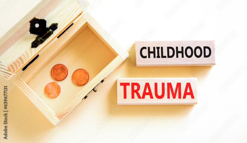 Childhood trauma symbol. Concept words Childhood trauma on beautiful wooden blocks. Beautiful white table background. Wooden chest with coins. Business psychology childhood trauma concept. Copy space.