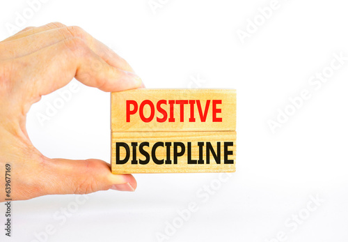 Positive discipline symbol. Concept words Positive discipline on beautiful wooden blocks. Beautiful white background. Businessman hand. Business psychology positive discipline concept. Copy space.