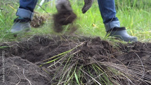 Female farmer using hands for prepare the soil for planting vegetables