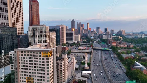 Drone footage of highways and buildings in Atlanta near Atlantic Station shot in 4k. Sideways pan of skyline in Atlanta at sunset. Close up shot o the buildings with sun reflection on buildings.