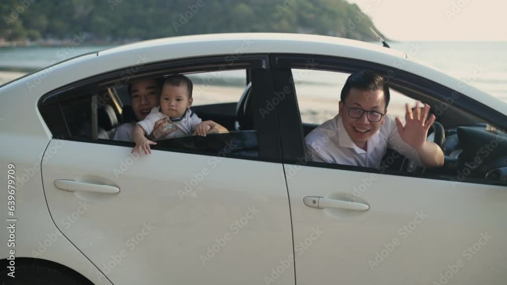 Tourism concepts of 4k Resolution. Asian parents and children waving goodbye in the car. Traveling by personal car. Tourism concepts of 4k Resolution. Asian parents and children waving goodbye in the car. Traveling by personal car.