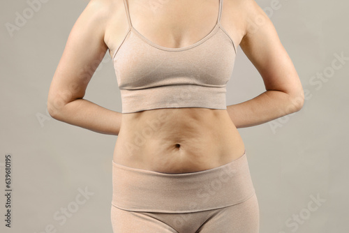 Loose skin on the abdomen after weight loss. Close-up. photo