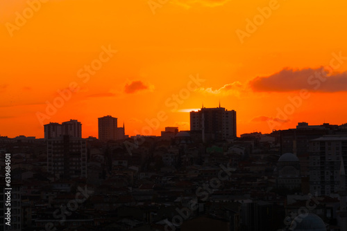 Colorful orange sunset sky over the city of Istanbul  Turkey in the evening - apartment  residential buildings silhouettes. Summer  architecture  cityscape and urban concept