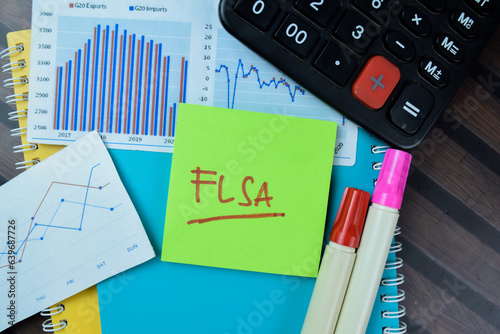 Concept of FLSA write on sticky notes isolated on Wooden Table. photo