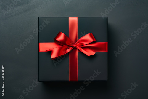 Black box with red ribbon on it and bow.