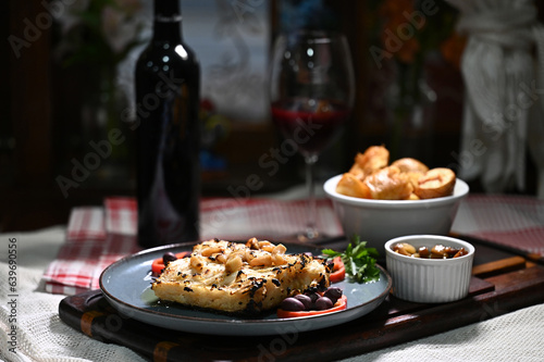 Fototapeta Naklejka Na Ścianę i Meble -  typical portuguese dish roasted codfish with onion garlic peppers and rustic babata lusitanian food