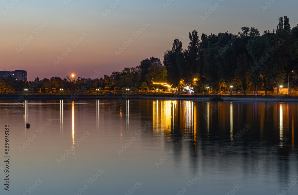 Beautiful sunset reflection on a lake in Chisinau public park