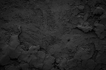Black or dark gray rough grainy stone or sand plaster texture background