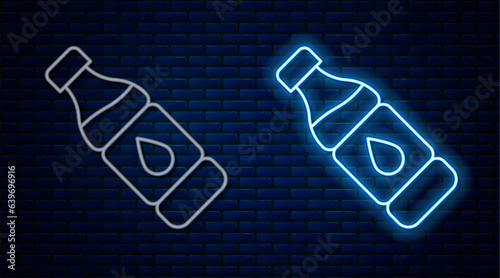 Glowing neon line Bottle of water icon isolated on brick wall background. Soda aqua drink sign. Vector