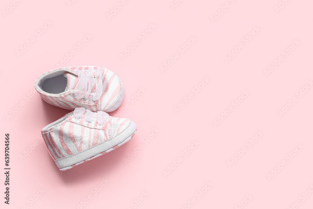 Stylish baby booties on pink background Stylish baby booties on pink background