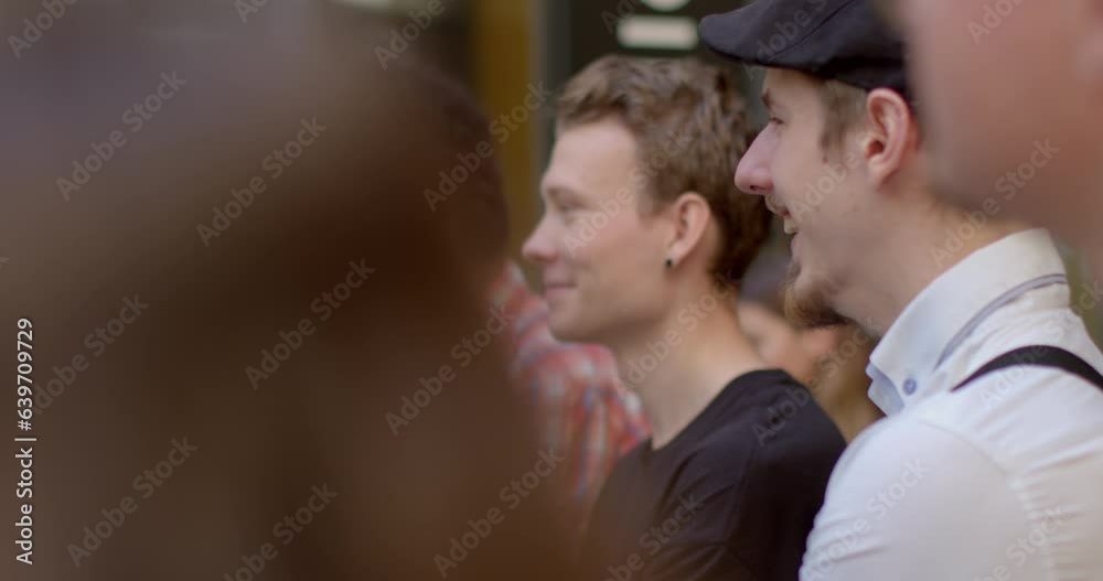 Portrait of a young man laughing out loud in company of people. Hormone that is produced during laughter is called endorphins. Body natural feel good chemicals can reduce stress levels. Elevate mood. Portrait of a young man laughing out loud in company of people. Hormone that is produced during laughter is called endorphins. Body natural feel good chemicals can reduce stress levels. Elevate mood.
