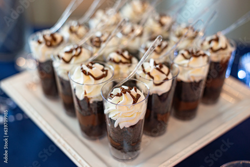 Mini parfait-mini dessert glass cylinder cups filled with chocolate, fudge and topped with whipped cream