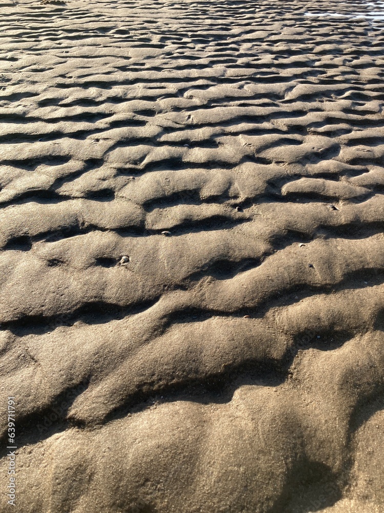 Beach sand wave pattern created by wind and waves Beach sand wave pattern created by wind and waves