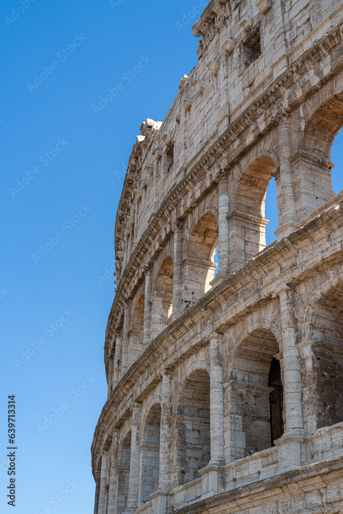 close up of Colosseum, Rome, Italy with blue summer sky behind it - Portrait 