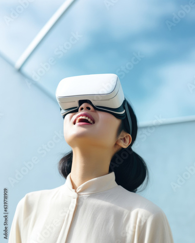 A young Asian woman looks intently through a VR headset entranced in the world of virtual entertainment.