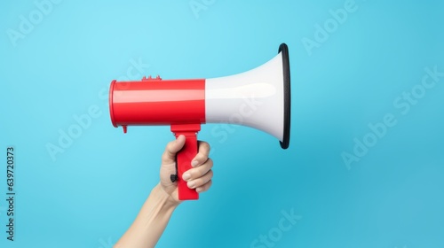 Photo of a person holding a red and white megaphone