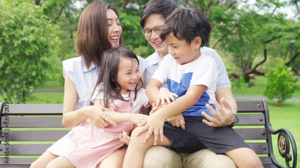 4K Happy Asian family parents and little kids enjoy and fun outdoor lifestyle on summer holiday vacation. Father, mother and child playing and relaxing together at park. Family relationship concept. 4K Happy Asian family parents and little kids enjoy and fun outdoor lifestyle on summer holiday vacation. Father, mother and child playing and relaxing together at park. Family relationship concept.