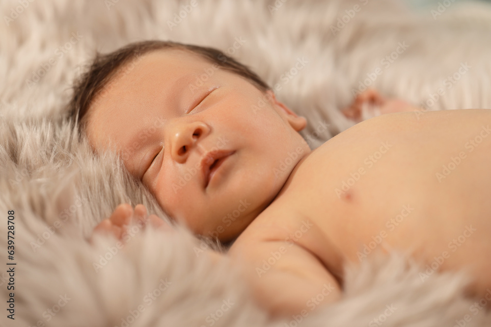 Cute newborn baby sleeping on fluffy blanket, closeup Cute newborn baby sleeping on fluffy blanket, closeup