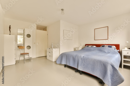 a bedroom with a bed, dresser and mirror on the wall behind it is a white cabinetd cupboards